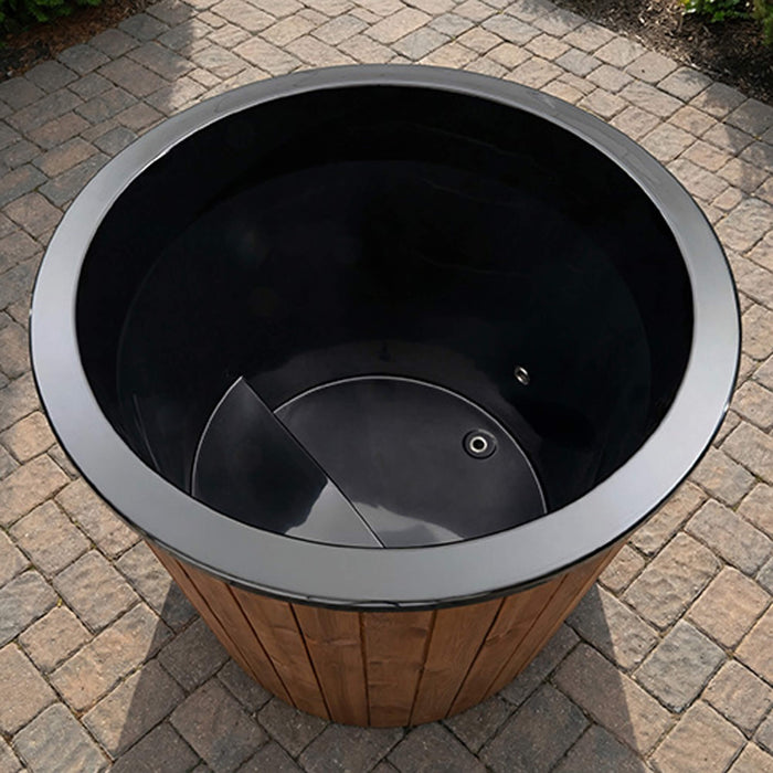Round black trash bin with wooden base on a paved surface