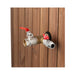 Brass outdoor faucet with red handles attached to wooden siding.